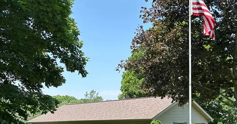 A brand new roof sitting under the American Flag tells you a lot about Ideal Roofing LLC. 