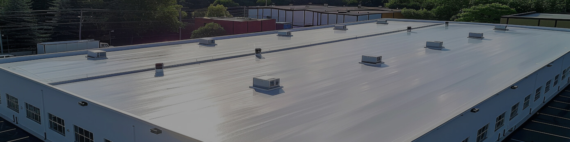 A modern commercial building in Grand Blanc with a flat roof system.