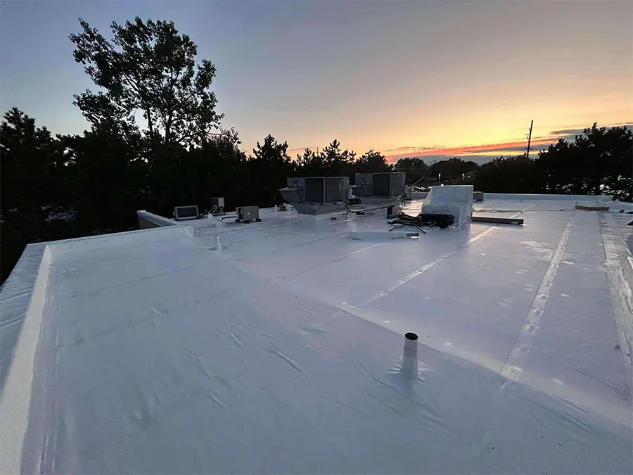 Sun setting on a newly installed Duro Last Systems commercial roofing membrane in Fenton Michigan Roofing contractor Ideal Roofing LLC.