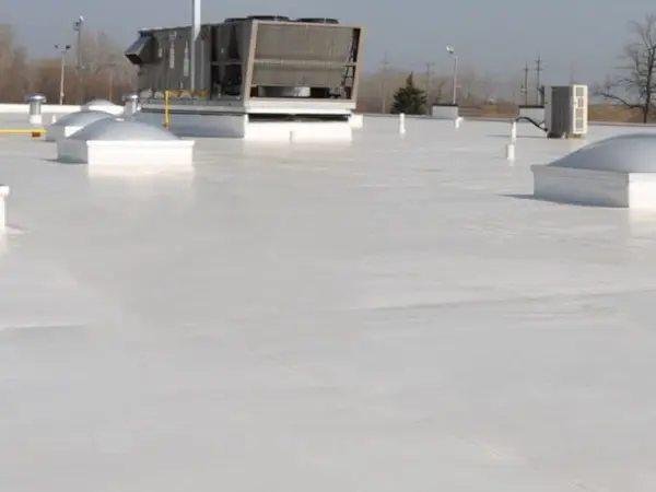 New installation of a white Duro-Last PVC membrane on a commercial roof, providing energy-efficient waterproofing by Ideal Roofing.