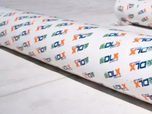 Custom fabricated rolls of Duro Last DLX PVC membrane for industrial flat replacement in Michigan.