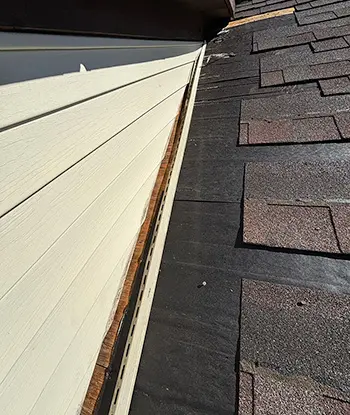 Beginning of residential roof repairs with top quality asphalt shingles on home in Flint Michigan.