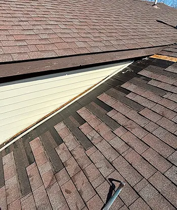 Progression of residential roof repairs with top quality asphalt shingles on home in Flint Michigan.