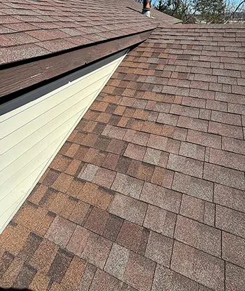 Completed residential roof repairs with top quality asphalt shingles on home in Flint Michigan.