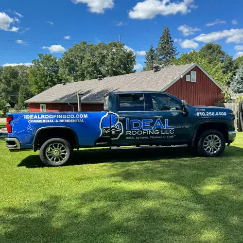 Ideal Roofing LLC company truck with company logo and contact information.