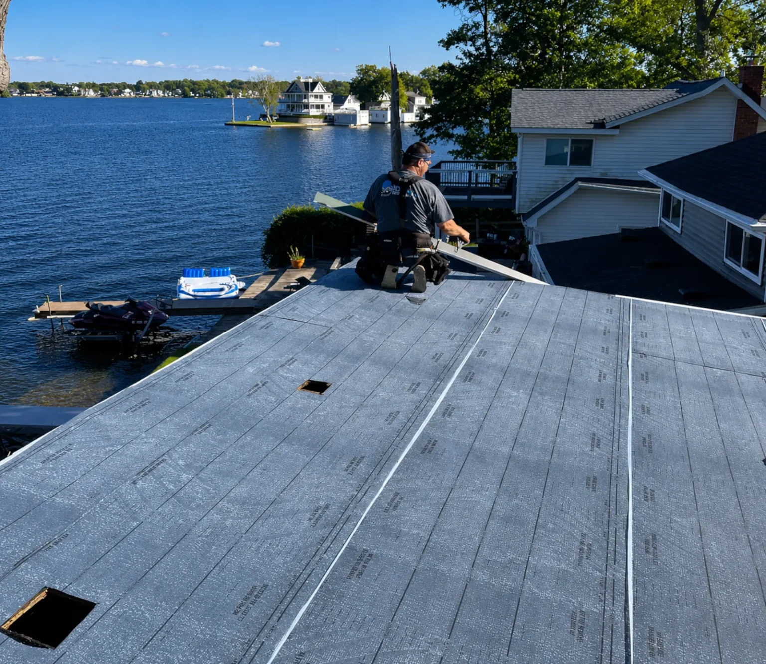 Ideal roofing roofer installing new low slope roofing in lake fenton michigan.