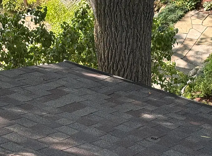 View of newly repaired roofing shingles from severe hail damage used for ideal roofing's roof insurance claims guide.