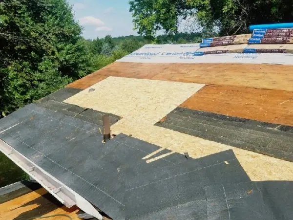 Newly installed sheets of roof decking after water damaged roof decking was removed by Ideal Roofing LLC.