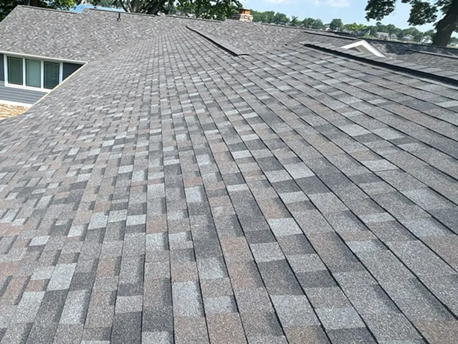 Brand new gray asphalt roof on a home in Fenton Michigan that was installed by a licensed by Fenton Michigan roofing contractor Ideal Roofing LLC.