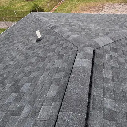 Top of residential roof with dimensional gray asphalt shingles that are new for home in Burton, MI.