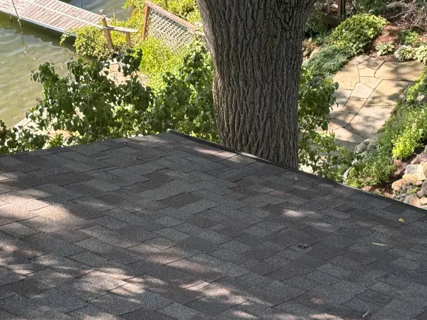 Completed shingle replacement on roof of home after storm damage tore the old ones off.