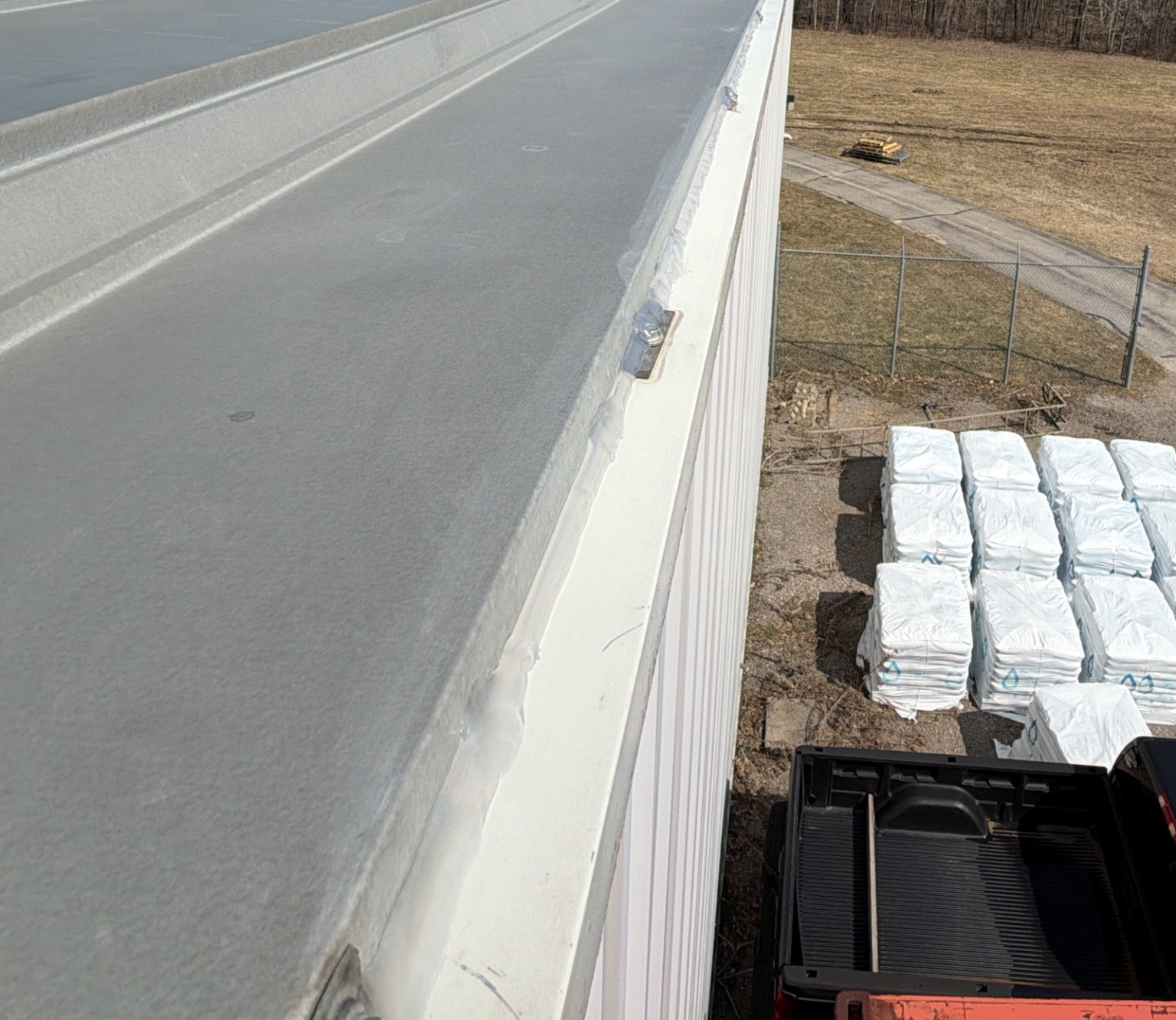 Completed metal edge repair on commercial flat roof.